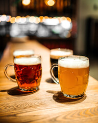Mugs of different craft beer at the bar blurry 