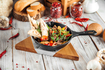 Mexican dish fajitos with beef vegetables and pita