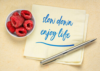 slow down and enjoy life reminder or advice - handwriting on a napkin, lifestyle and reducing...