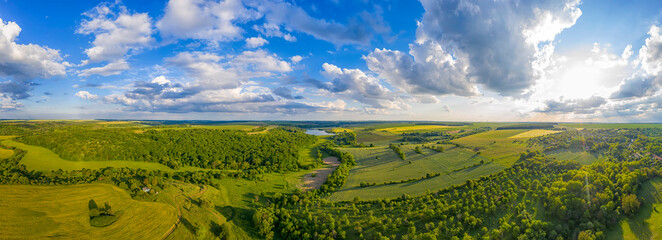 Amazing aerial panorama from the drone of beautiful fresh green countryside at summer