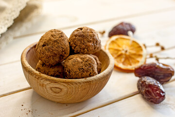 Raw food sweets handmade balls of seeds, nuts, dates and coconut, close-up