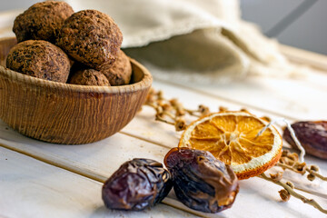 Raw food sweets handmade balls of seeds, nuts, dates and coconut, close-up