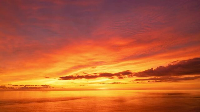 4K Timelapse of Amazing dramatic sunrise sky or sunset sky and clouds flowing over tropical sea Beautiful light nature in the sky