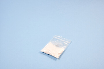 small bag of cocaine on blue background