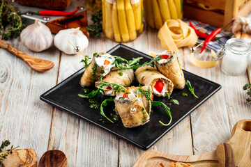 Snack eggplant rolls with tomatoes garlic sauce