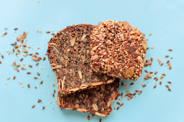 Sliced whole grain bread rye with seeds flax, sunflower, pumpkin and sesame.Healthy food, eco-friendly natural products. Fresh bread on a pink background.