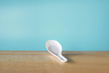 white porcelain spoon on wooden table