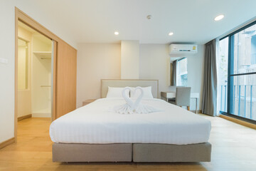 White pillows on wooden bed in minimal bedroom interior