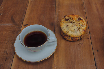 delicious cookies wrapped in gift ribbon with cup coffee