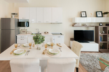 Stylish kitchen interior with dining table and chairs
