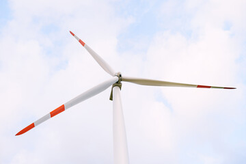 A close-up of the blades of the washed huge wind turbine against the sky.