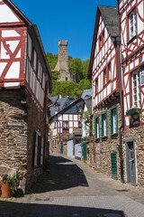 A narrow alley in Monreal / Germany in the Eifel with a view of the Philipps castle