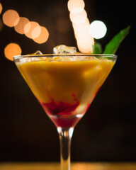 cocktail with ice and lights behind