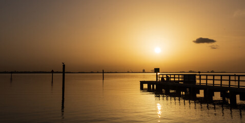 Obraz premium Friends on the Dock early morning, Sahara Dust storm Affects here in Florida