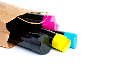 Set of cartridges for color laser printing lie on a table in a paper bag on a white background