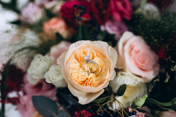 Preparing for the wedding. Wedding rings and roses. Wedding details for the ceremony.
