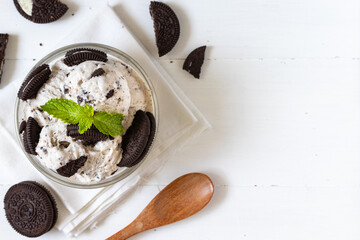 Chocolate cookie and ice cream in a glass bowl with mint leaf on white wooden background, summer sweet and dessert