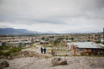 Informal Settlement in a Township with gloomy grey cloud sky in  Cape Town South Africa