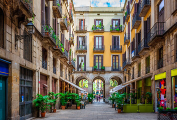 Fototapeta na wymiar Old narrow street in Barcelona, Catalonia, Spain. Architecture and landmark of Barcelona. Cozy cityscape of Barcelona