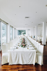 Flower decoration of wedding tables.
Banquet table setting and decoration. Cutlery on the table. 