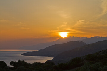 Silhouettes of hills on the coast of Crete at sunset