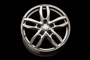 silver SUV Allloy wheel, close-up on a black background