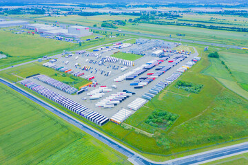 Aerial top view of white cargo trailer parking, trailer line up. Delivery, logistics.