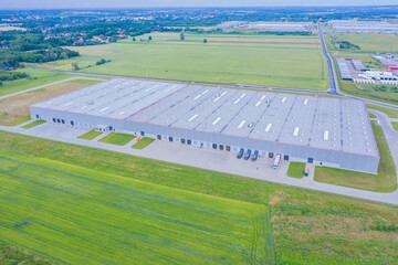 Aerial Shot of Industrial Loading Area where Many Trucks Are Unloading Merchandise.