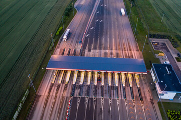 Car traffic transportation on multiple lanes highway road and toll collection gate, drone aerial...