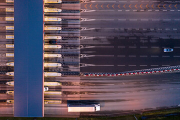 Car traffic transportation on multiple lanes highway road and toll collection gate, drone aerial...