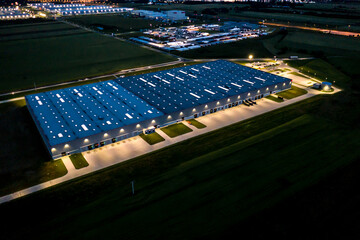 Night Aerial view of goods warehouse. Logistics center in industrial city zone from above. Aerial...