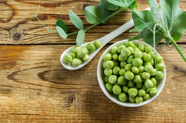 Young green peas in a white bowl