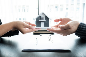 The real estate agent gives the house to a new owner's client after completing the signing of the lease and formally completing home insurance. Rental and insurance concepts