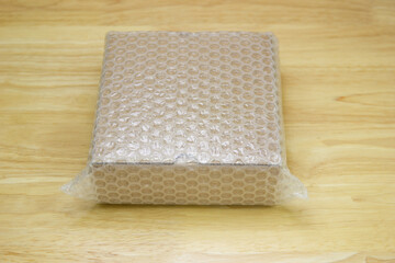 Bubbles covering the box by bubble wrap for protection product cracked on wood table