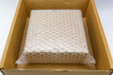 Bubbles covering the box by bubble wrap for protection product cracked on wood table