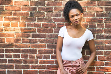 Colombian fashion woman outside close to a brick wall