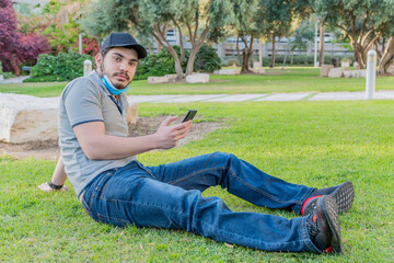 Obraz premium man with protective mask checking his mobile