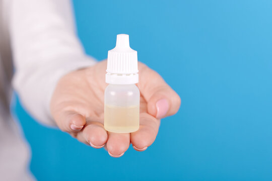 Eye Drops Bottle In Hand.