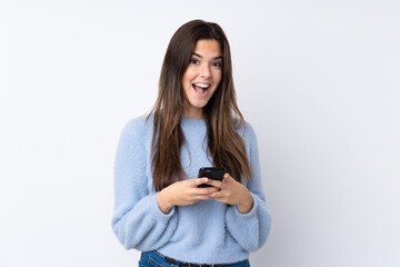 Fototapeta premium Teenager girl over isolated white background surprised and sending a message