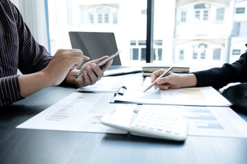 Two business leaders discussing the charts and graphs showing the results, Planning to start a new strategy for big success In the office