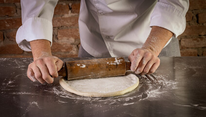 Fresh pizza dough being prepared. The process of making pizza