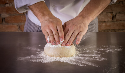 Fresh pizza dough being prepared. The process of making pizza