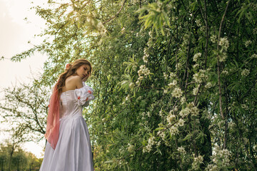 Princess walking in flowering garden