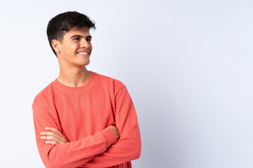 Handsome man over isolated blue background happy and smiling