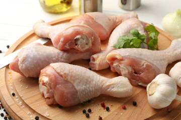 Board with raw chicken meat and spices, close up. Cooking chicken