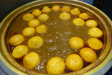 Fish balls frying in oil in skillet, Hong Kong market 