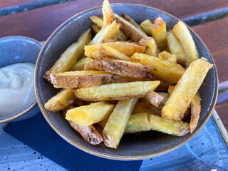 Close up of isolated bowls with mayonnaise sauce and french fries with potato peel - Netherlands