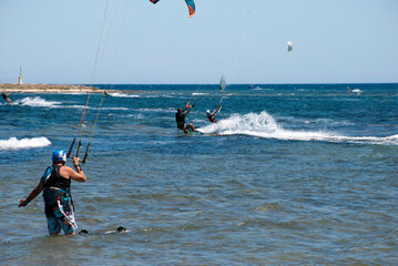 Athens, Greece, July 2020: Windsurfing and Kite Surfing on a very sunny day 
