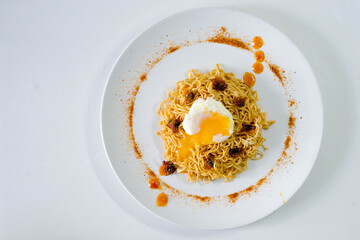 fried egg with noodle on a plate