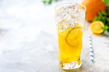orange juice or lemonade with mint or lemonade with mint  transparent glass cup with mint takeaway drink Menu concept serving size food background top view copy space for text organic healthy eating